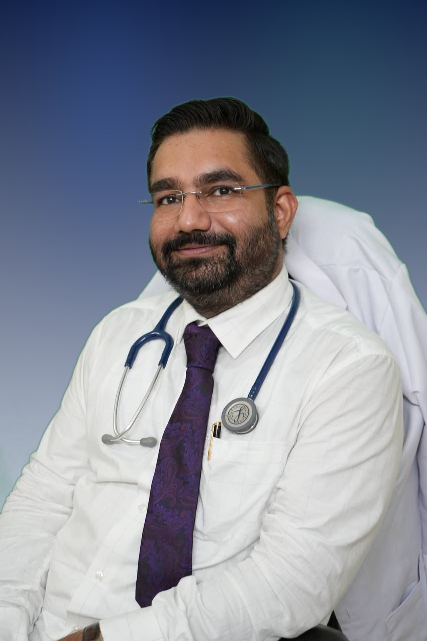 Dr. Kulwant Yadav seated portrait with studio background